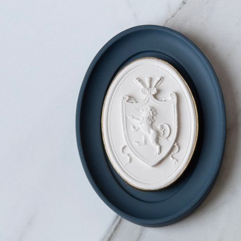 Part of our elegant Statuette collection, this beautiful and dimensional cast plaster intaglio depicts a Lion Crest centered within an oval frame. With a beautiful French Blue background and black intaglio edge, these are all handmade here in the U.S. Each intaglio arrives framed and ready to be installed, either on its own- or as apart of a collection. These are perfect for adding dimension to any gallery wall or art vignette! Specs & Care Handmade plaster cast intaglio with gilded edge Size: 5 Art Vignette, Lion Crest, Ceramics Inspiration, Plaster Cast, Glassware Kitchen, A Lion, French Blue, Oval Frame, Candle Shop