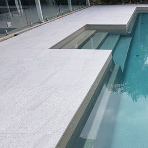 Photos of Pool Pavers and Stone Tiles and matching coping tiles Tiles Around Pool Area, Pool Surround Ideas Deck, Pools With Grey Tiles, Outdoor Pool Tiles, Modern Travertine Pool Deck, Pool Surround Tiles, Pool Deck Pavers Ideas, Porcelain Tile Pool Deck, Modern Pool Coping Ideas