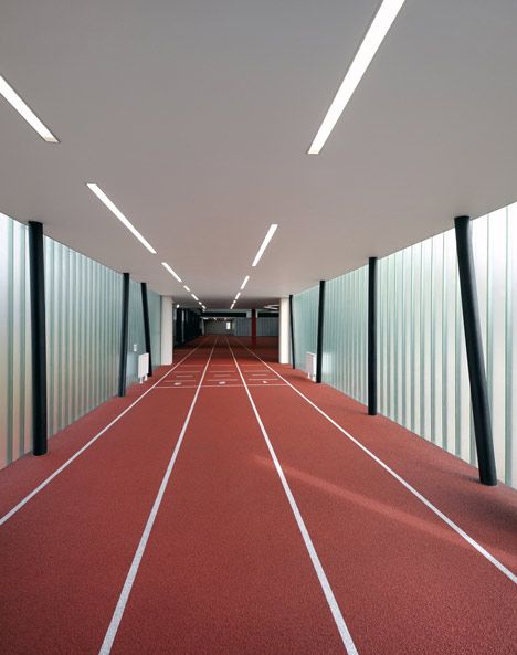 To create a full-length running track inside this refurbished gym in the Czech Republic, Prague studio QARTA Architektura added a translucent extension that projects out on stilts. Sports Pavilion, Aje Athletica, Athletics Track, Indoor Track, Floor Pattern, Gym Interior, Colour Photo, Community Centre, Running Track