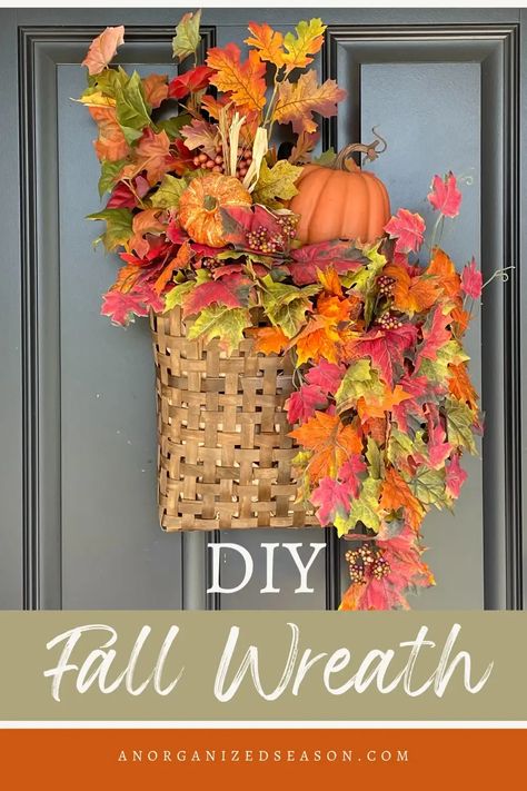 Basket wreath hanging on front door with fall leaves and orange pumpkins. Make A Fall Wreath, Inexpensive Wreaths, Fall Wreaths For Front Door, Autumn Diy, Easy Fall Wreaths, Decorated Wreaths, Basket Wreath, Faux Leaf, Faux Pumpkins