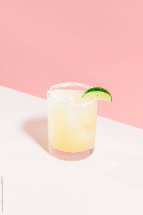 A single perfect classic margarita on a white and pink background. This image is exclusively licensable as a royalty-free stock photo through Stocksy United. #StockPhoto #CocktailPhotography #cocktail #Drinks #Alcohol #Margarita Classic Tequila Cocktails, Virgin Margarita, Bramble Cocktail, Sunset Drinks, Cocktail Kit, Drinks Photography, Frozen Margaritas, Popular Cocktails, Beverage Photography