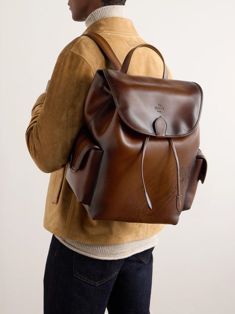 Berluti's backpack is crafted from its own Venezia leather in a deep 'Cacao' brown. Its two external pockets are sized for quick-access essentials – like hand sanitiser and aftershave – while its interior can easily stow a spare sweater, flask and a couple of books. It secures with drawstrings and a magnetic flap. Backpack Leather Man, Leather Photography Product, Leather Backpack Aesthetic, Porter Backpack, Mens Backpack Fashion, Weekend Bags, Men Backpack, Leather Backpack For Men, Backpack Outfit