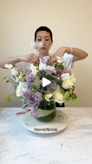 NYC Wedding and Events Florist on Instagram: "Part 3 Purple. The final and largest one.  ☑️Recipe: hydrangea, rose, spray rose, lilac, snowball viburnum, dusty miller, lisianthus, sweet peas, and anemones ☑️Sprite + bleach combo = flower food + bacteria killer ☑️Grid the vase with 5 initial stems of rose/spray rose ☑️Hydrangeas act to fill in the spaces but keep them loose ☑️Clean off the little leaves so the leaves don’t compete with the blooms in the arrangement.  ☑️Let each flower breathe and shine / have their moment ☑️Like, Share, Follow for more flower arranging   #floristsofinstagram #flowerarrangement #flowerarranging #flowerclass #rachelchofloral" Hydrangea Flower Arrangements Vase, Spray Roses Arrangement, How To Arrange Flowers, Dried Hydrangeas Centerpiece, Snowball Viburnum, Hydrangea Flower Arrangements, Floral Designs Arrangements, Hydrangea Vase, Large Hydrangea