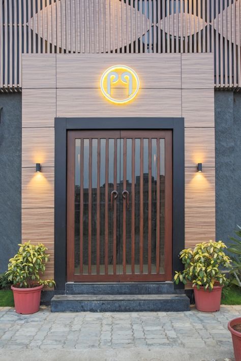 Restaurant Designed With Delicacy & Elegance | Big Nose Designs - The Architects Diary Restaurant Doors, Hotel Doors Design, Iron Main Gate Design, Restaurant Facade, Trendy Restaurant, Restaurant Door, Restaurant Entrance, Garage Door Types, Restaurant Exterior