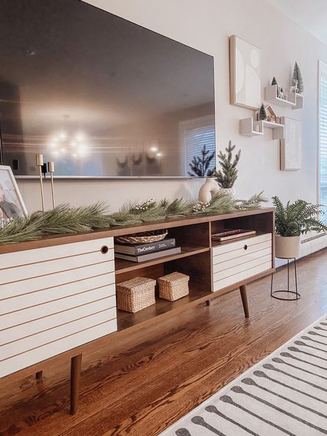 Greenery On Tv Stand, Picture Frames On Tv Stand, Living Room Designs With Tv Stand, Styling A Tv Stand Living Rooms, Styling Tv Stand Living Rooms, Long Tv Stand Decor, Winter Tv Stand Decor, Holiday Tv Stand Decor, Boho Living Room Tv Stands