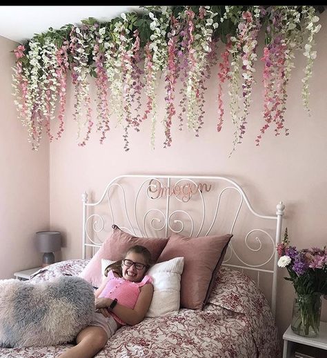 Faux Flower Wall Hanging, Bedroom Flower Ceiling, Bedroom Ceiling Flowers, Flower Hanging From Ceiling Bedroom, Flower Vine Ceiling Bedroom, Wisteria Canopy Bedroom, Flowers On Headboard, Hanging Flowers Bedroom Aesthetic, Hanging Flower Bedroom