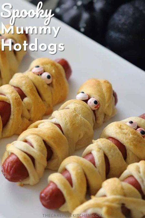 These Mummy Hot Dogs are an adorable Halloween dinner or party appetizer that couldn’t be easier. Made with crescent roll dough, they’re the perfect festive finger food that uses just a few basic ingredients. #thecarefreekitchen #halloween #partyappetizers #hotdogs #mummyhotdogs #kids #fingerfood #mummydogs Halloween Hotdogs Fingers, Ghost Hotdogs, Hot Dogs Crescent Rolls Recipes, Christmas Hot Dogs For Kids, Mummy Wrapped Hotdogs, Mummy Dogs For Halloween, Hot Dog Mummies Crescent Rolls, Halloween Hotdogs Ideas, Hot Dogs With Crescent Rolls