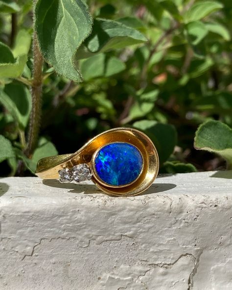 I have a case of #bluemonday but looking at sunny photos of this gorgeous vintage thing sure is helping! 🌞💙 A modernist 1960s black opal & diamond ring wrapped up in 18ct gold. I strongly suspect that is a lightning ridge solid black opal sitting in that cup of buttery gold, but the only way to know for sure is to take it out of the setting and risk ruining the whole thing 😕 Nobody wants that. Priced as a doublet (because that’s one Easter egg I’m not going to crack open) find her on my web... Black Opal Engagement Ring, Opal Diamond Ring, Opal Engagement Ring, Opal Engagement, Lightning Ridge, Wrap Rings, Black Opal, The Only Way, Easter Egg