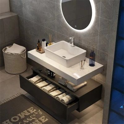 Combining an aura of minimalism and multifunctional style on a grand scale, this wall-mounted vanity set is versatile enough to fit many bathroom styles. The rectangular vessel sink is integrated on the faux marble countertop for a flawless aesthetics, while a single hole is drilled for a faucet of your choice. With a smooth countertop, it offers a spot to stash your morning routine must-haves. Boasting a large drawer, it offers ample room for clothes, toiletries, hairdryer and other sundries, w Attic Bedrooms, Drømme Bad, Rectangular Vessel Sink, Floating Sink, Inspiration Bathroom, Floating Bathroom Vanity, Bad Inspiration, Floating Vanity, Bathroom Design Luxury