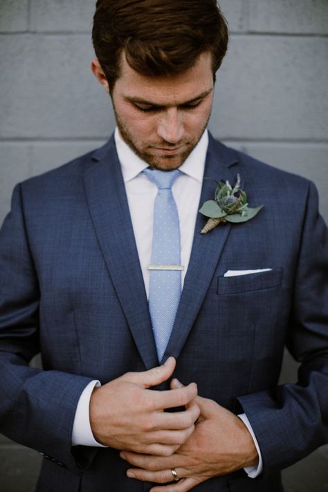 Handsome groom in dark navy suit getting ready before the ceremony. Navy blue suit looks good paired with light blue tie. #navysuit #groomattire #smokyhollowwedding Light Blue Tie With Navy Suit, Blue Suit Blue Tie Wedding, Navy Suit With Dusty Blue Tie, Tie With Navy Blue Suit, Navy Suit With Blue Tie, Dark Navy Blue Groomsmen Suits, Navy Blue Suit With Light Blue Tie, Dark Blue Suit With Light Blue Tie, Navy Suit Light Blue Tie