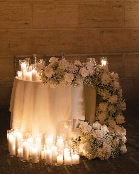 Our newlyweds look stunning amid this cozy atmosphere✨ Using the classic white rose and baby’s breath combo, we created wedding decor unlike any other! We elevated the space with tall centerpieces and candles, which creates this romantic ambiance throughout the venue. To find out more, schedule a wedding consultation by calling or texting as at (215)437-1913 We look forward to bringing your dreams to life! ☺️🌸 #wedding #weddingphilly #weddingphiladelphia #weddinginspo #weddingideas #weddi... Elegant Candle Centerpieces Wedding, Candleopera Centerpieces Wedding, Baby's Breath Sweetheart Table, Sweetheart Table Wedding Candles, Wedding Centerpieces Tall, Wedding Candle Decor, Candleabras Wedding Centerpiece, Candles And Flowers Centerpieces, Babies Breath Centerpiece