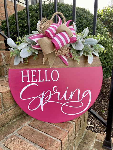 Welcome Spring into your home with this vibrant "Hello Spring" hanging door sign. Perfect for your spring decor! Elevate your doorstep with this delightful sign and let the bright hues of the season make a statement. Hello Spring Hanging Door Sign Made to order and ships within 3-5 Business Days Sign Details: - Hand cut wood round sign - 2 size options 15x15 or 18x18 inches (18x18 inches pictured) .5 inch thick - front and back painted/stained (depending on style) - Outdoor protective sealer app Round Spring Signs, Spring And Summer Signs, Circle Wood Door Hangers, Pink Welcome Sign Front Doors, Diy Circle Door Sign, Hello Spring Door Sign, Wood Spring Signs, Trending Signs Decor, Diy Spring Signs