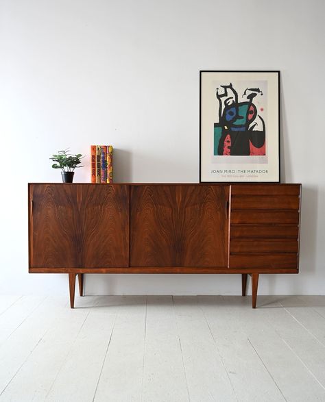 Discover the elegance and functionality of this original 1960s Danish rosewood sideboard, a quintessential piece that captures the essence of Nordic modernism. Crafted with meticulous attention to detail, this sideboard blends style, functionality, and impeccable craftsmanship. Dimensions (in cm): Width: 225cm/88.58inch Height: 105cm/41.33inch Depth: 47cm/18.50inch The refined structure features two sliding doors on one side and six drawers with hidden handles on the other. This versatile design Midcentury Sideboard Living Room, Mid Century Side Board, Sideboard Bedroom, Sideboard Living Room, Midcentury Sideboard, Dark Wood Sideboard, Mid Century Modern Storage, Mid Century Modern Sideboard, Mid Century Cabinet