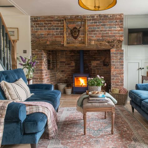 Find out how the owners transformed this once dark and dingy cottage that hadn't been touched in decades Inglenook Fireplace Cottage, Small Living Room With Brick Fireplace, Scottish Style Living Room, Cosy Country Living Room, Tiny Cottage Living Room, Cottage Lounge Ideas, Inglenook Fireplace Ideas, Colorful Cottage Living Room, English Cottage Fireplace