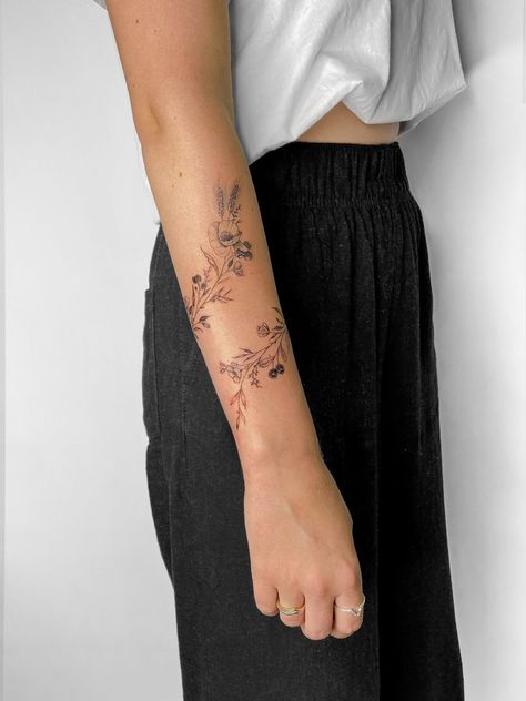 Flowers Around Forearm Tattoo, Fineline Floral Tattoo Arm, Women Vine Tattoo Arm, Soft Sleeve Tattoos For Women, Back Of Arm Birth Flower Tattoo, Dainty Floral Arm Wrap Tattoo, Dainty Lower Arm Tattoos, Wildflower Arm Band Tattoo, Floral Tattoo Design Wrap