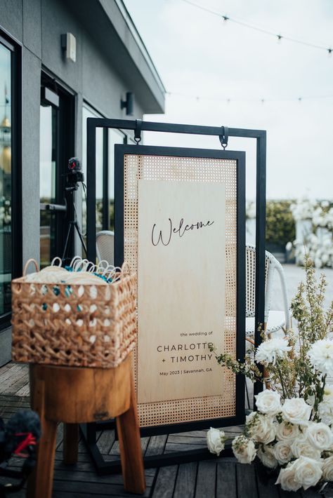 Black and rattan wood wedding welcome sign for a rooftop celebration in Savannah, Georgia. Planning by Plume Events and photo by 7Nine Photography. Rattan Wedding Invitation, Rattan Signage, Rattan Seating Chart, Unique Wedding Welcome Sign Ideas, Wood Wedding Signage, Rattan Wedding Decor, Wedding Add Ons, Unique Welcome Signs Wedding, Diy Wood Wedding Signs