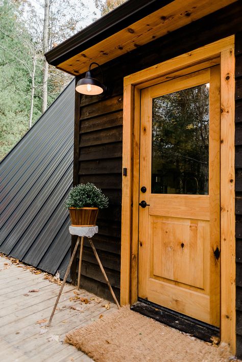 Wood Cabin With Black Trim Exterior, Build An A Frame Cabin, Den Outdoors Cabin, Cute Cabins In The Woods, Black Cabin With Wood Accents, Building A Cabin In The Woods, A Frame Cabin Renovation, Build A Cabin On A Budget, Black Cabin In The Woods