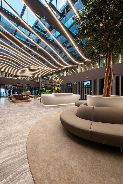 Gallery of Coverlam Medusa in Hillside Office Building - 3 Office Building Reception Lobby, Modern Atrium Design, Entertainment Building Design, Atrium Lighting, Airport Lighting, Building Entrance Lobby, Lobby Ceiling Design, Mall Architecture, Office Lobby Design