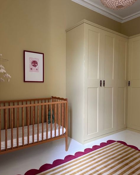 Farrow & Ball Hay No.37 is a dusty, modest yellow that has a distinctly green undertone which gives it an established feel, creating peaceful spaces. We think it fulfilled its obligation in this lovely nursery, don’t you? Walls and wardrobe painted in Hay Dead Flat. 📸: @joannalari Repost: @farrowandball Sample pots available at Hirshfield’s Edina and Roseville locations. Yellow Nursery Walls, Yellow Baby Room, Yellow Kids Rooms, Eclectic Kids Room, Eclectic Nursery, Guest Bedroom/office, Yellow Ceiling, Oval Room Blue, Yellow Nursery