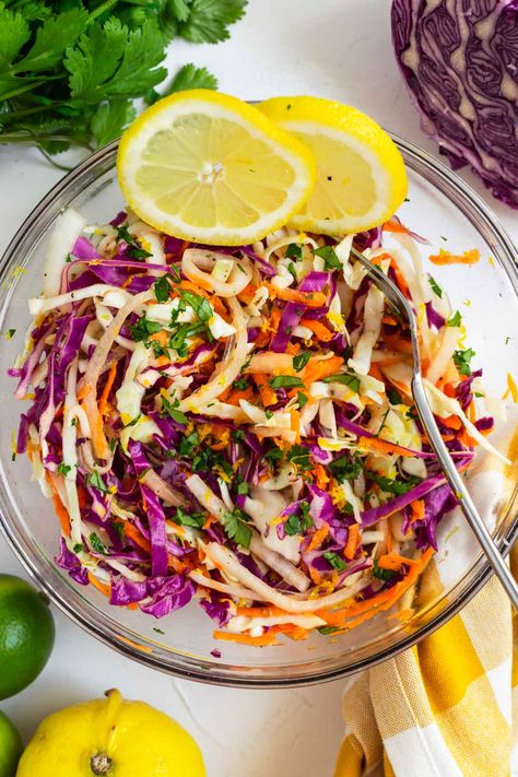 This sweet citrus slaw is a deliciously crisp, tangy and lightly sweet mix of green cabbage, red cabbage, and carrots topped with a bright blend of orange, lime, and lemon juice, olive oil, and maple syrup. This recipe has been a family favorite for folding into fish and shrimp tacos, layering into wraps and bowls, or pairing as a tart side with grilled burgers, chicken, or steak. #citrusslaw #citruscoleslaw #slaw #slawrecipe #cabbageslaw #bbqsidedish Mexican Coleslaw Recipe, Citrus Slaw, Mexican Coleslaw, Cabbage And Carrots, Lime And Lemon, Healthy Coleslaw, Homemade Coleslaw, Side Dishes For Bbq, Broccoli Slaw