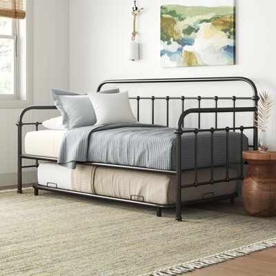 This daybed and a trundle have an openwork silhouette in a dark bronze finish to create a coastal farmhouse accent in your living room or den. It's made from metal and has spindles with finials along the sides and back for a traditional farmhouse look. This daybed has slats, so you don't have to add a box spring under the mattress. Plus, it arrives with a trundle to offer you a spare sleep spot for extra overnight guests. | Three Posts™ Rondo Twin Daybed w / Trundle Metal in Black / Brown / Yell Twin Daybed With Trundle, Twin Daybed, Metal Daybed, Daybed With Trundle, Traditional Farmhouse, Day Bed, Daybed, Futon, Bronze Finish