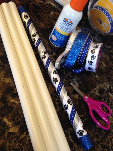 PVC Pipe turned into Spirit Sticks for each girl at the end if the season! Spirit Stick Ideas Diy How To Make, Cheer Spirit Sticks Ideas, Diy Cheer Spirit Stick, Cheerleader Spirit Sticks, How To Make Spirit Sticks Cheer, Dance Spirit Sticks, Cheerleading Spirit Stick Ideas, Cheer Competition Spirit Sticks, School Spirit Stick