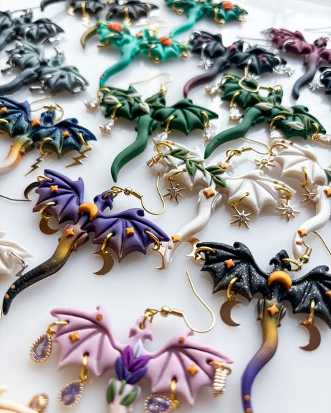 DRAGON EARRINGS!🐉 they’re back and theres a lot🧍🏻‍♀️1400 pairs of them and i feel bonkers dropping this saturday april 6th at 1PM pacific and if you miss them they’ll be restocking the week after too, april 13th at 1PM pacific ‼️✨ this is THE MOST i’ve ever had drop at once (or twice i guess because they’ll be on two seperate weekends), hopefully these will be more than enough for everyone who has ever wanted them or even seen these from me ever Polymer Clay Dragon Earrings, Polymer Dragon, Sculpted Jewelry, Handmade Aesthetic, Polymer Clay Dragon, Book Earrings, Clay Dragon, Handmade Clay Jewelry, Dragon Earrings