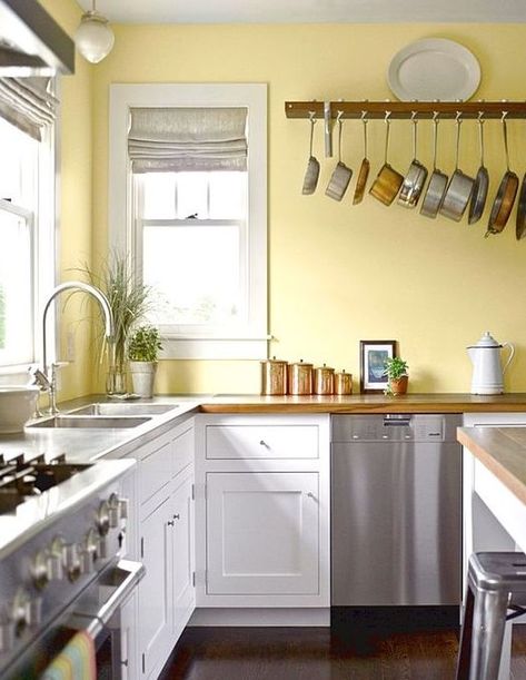 a retro kitchen with a lemon yellow wall, white cabinets, metal appliances and copper touches Yellow Kitchens, Yellow Kitchen Walls, Kitchens White, Outdoor Kitchen Cabinets, Kitchen Walls, Kitchen Wall Colors, Yellow Kitchen, Diy Kitchen Cabinets, Yellow Walls