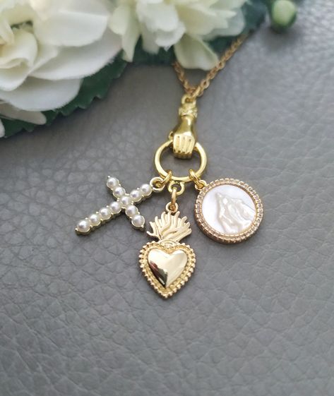 Gold Sacred Heart Necklace, Mother of Pearl Virgin Mary and Cross Pendant Jewelry, Catholic Gift Unique necklace with mother of pearl Virgin Mary, cross and sacred heart charms It makes a beautiful and thoughtful gift for your loved ones. The chain is 18k gold plated Stainless steel. Our gold plated jewelry is coated with protective lacquer, but always keep in mind that these are not fine metals - avoiding contact with perfumes, creams, salt water and other elements will help to keep the beauty Sacred Heart Necklace, Cross Gift, Catholic Jewelry, Jewelry Accessories Ideas, Catholic Gifts, Christian Jewelry, Unique Necklace, Cross Jewelry, Plated Jewelry