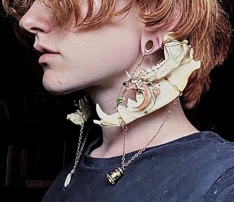 These double gauge hangers/earrings are made from naturally sourced jawbones collected by the maker. They also feature two distinct pendants that display angelic and astrological themes to create a very whimsical, elegant piece with a dark undertone. They are recommended to be worn with silicone ring gauges to create a more comfortable experience but can be worn with metal, or bare ears. They are designed for gauged ears and create a weight for the stretched lobe, but could potentially be worn w Character Design Jewelry, Cool Ear Rings, Unique Accessories Fashion, Gauged Ears With Piercings, Warlock Jewelry, Jaw Jewelry, Double Pierced Ears, Ornamental Jewelry, Earrings Reference