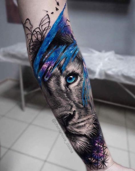 galaxy-watercolor-tattoo-around-lioness-head-with-blue-eyes-forearm-tattoo-lion-hand-tattoo Arte Trash Polka, Lion Cub Tattoo, Lion Tattoo On Thigh, Lion Hand Tattoo, Lion Forearm Tattoos, Protection Tattoo, Lion King Tattoo, Lioness Tattoo, Eyes Tattoo