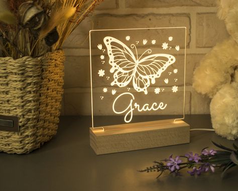 "Personalized butterfly gifts for baby girl could be differ. It could be some nursery decor like wallpaper or stickers. Or it could be a name light signs with butterfly outline etched on it. We propose a night light with the baby name along with the butterfly design or any other insect or animal. Handmade of solid wood base with a white color USB cable to plug, it brings enough light to nursery and still not so bright to wake up the sleeping baby in the middle of the night. Made of safe acrylic Butterfly Night Light, Baby Niece Gifts, Sleepover Room, Butterfly Outline, Newborn Schedule, Butterfly Nursery, Baby Niece, Baby News, Baby Event