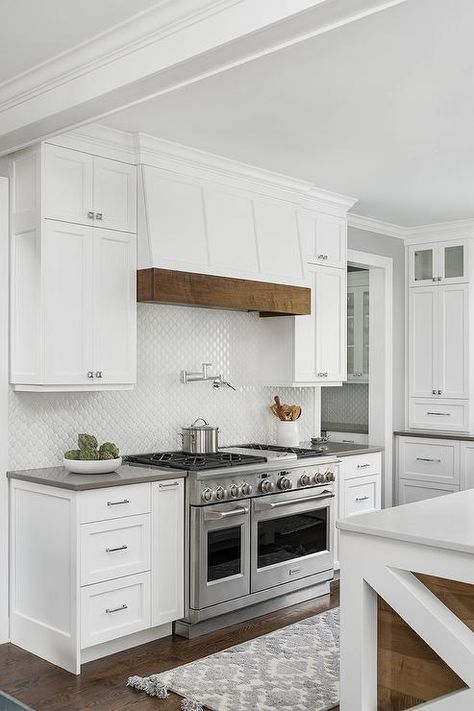 Cottage style range hood features a wood trim above a swing arm pot filler mounted on white arabesque backsplash tiles completing a cooktop design. Kitchen Hood Ideas, Kitchen Hood Design, Kitchen Vent Hood, Kitchen Vent, Kitchen Country, House Farmhouse, Kitchen Range Hood, Kitchen Hoods, Style Cottage