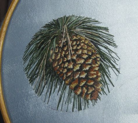 Pine cone embroidery completed.  By Annika Zenna.  Still on the hoop.   Will be mounted in a small (built to fit) circular wooden frame to be designed and built by Annika's husband. Pinecone Embroidery Pattern, Pine Bough Embroidery, Pine Cone Cross Stitch Pattern, Pine Cone Embroidery Pattern, Pine Cone Embroidery, Embroider Pine Tree, Embroidery Hacks, Embroidered Items, Hand Embroidery Projects