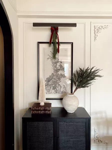 Art light (battery operated), small cabinet, vase with branches, Christmas decor for the home, Christmas, Christmas aesthetic, art art prints, home, entryway ideas, entryway decor | @prettyinthepines, New York City Lifestyle Blog #Christmas #decor #home Entryway Console Christmas Decor, Modern Classic Christmas Decor, Small Cabinet Decor, Christmas Decor Entryway, Hallway Nook, Christmas Entryway Decor, Minimal Christmas Decor, Holiday Entryway Decor, Christmas Foyer