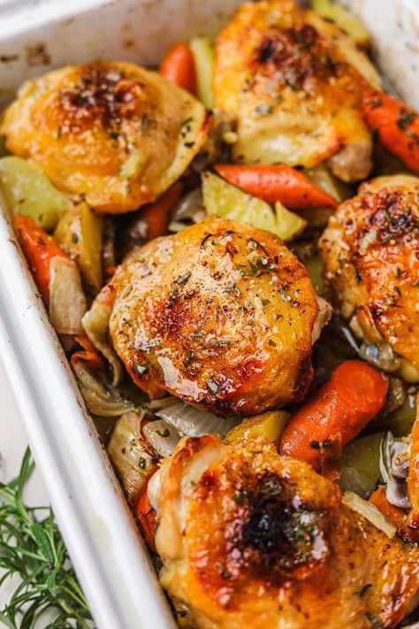 Roasted Chicken Thighs and Vegetables is an easy, hearty one-pan dinner recipe that results in crispy, juicy chicken and flavorful vegetables. Just toss the chicken, potatoes, onions, and carrots in mustard, honey, and olive oil, season, then roast in the oven until golden! Roasted Chicken Thighs And Vegetables, Roast Chicken Thigh Recipes, Chicken Thighs In Oven, Oven Roasted Chicken Thighs, Roasted Chicken And Potatoes, Potatoes Onions, Hearty Dinner Recipes, Roasted Chicken Thighs, Flavorful Vegetables