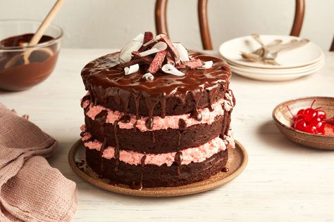 This Cherry Ripe layer cake recipe will delight your guests. Taking inspiration from the classic chocolate bar, this decadent cake has layers of chocolate sponge with cherry and coconut filling. It's sure to be a show stopper at your next event. Cherry Ripe Recipes, Most Popular Dessert Recipes, Cherry Ripe Slice, New Desserts, Chocolate Ganache Icing, Cherry Cake Recipe, Ultimate Chocolate Cake, Popular Desserts Recipes, Popular Dessert