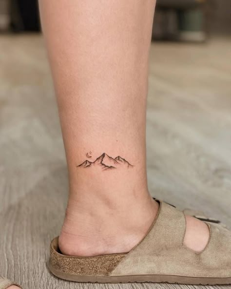 Mountain tattoo located on the ankle. Mountain Tattoo Unique, Exploration Tattoo Ideas, Nature Tattoos Mountain, Matching Mountain Tattoos For Best Friends, Mountain Tattoo Placement, Mountains Small Tattoo, Mountain Tattoo Back, Mountain Tattoo Back Of Neck, Mountain Tattoo Outline