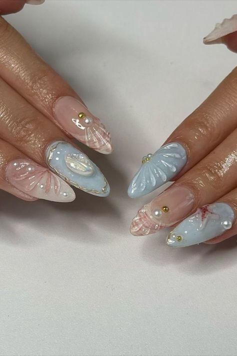 Beach nails in a soft blue color reminiscent of the ocean, adorned with shells and starfish, and accented with pink and white 3D shells by @gelxbysum (IG) create a dreamy and vibrant manicure. This design combines serene ocean hues with playful beach motifs and detailed 3D elements, offering a fresh and charming look perfect for summer. Explore a collection of stunning beach nail ideas on Nailustrous and get inspired for your perfect summer manicure! Beach Nail Ideas, Beach Nail Designs, Beach Nail, Ocean Hues, 3d Elements, Summer Manicure, Coastal Vibes, White Nail Designs, Beach Nails