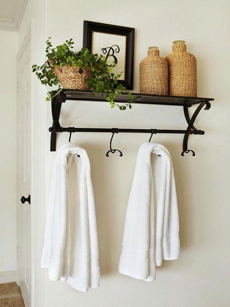 Don't settle for basic towel hooks sold in the bath department -- go beyond the standard options with a more decorative shelf-and-hook combo. Use this bathroom decorating idea to display accessories and toiletries above and hang towels and robes below. #BathroomStorage Space Bathroom, Decorative Shelving, Bathroom Decorating, Room Shelves, Towel Rack Bathroom, Small Bathrooms, Bathroom Redo, Stylish Bathroom, Small Bathroom Decor