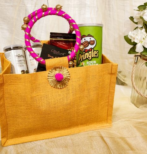 Make your wedding guests feel warm and special and welcome them with these reusable room hamper baskets, bags and trays options. Room Hampers For Wedding Guests, Indian Wedding Welcome Bags, Gift Hampers For Wedding Guests, Room Baskets For Wedding, Welcome Hampers For Wedding Guests Indian, Indian Wedding Favors For Guests Welcome Bags, Welcome Hampers For Wedding Guests, Wedding Hampers For Guests Basket Ideas, Indian Wedding Hampers For Guests