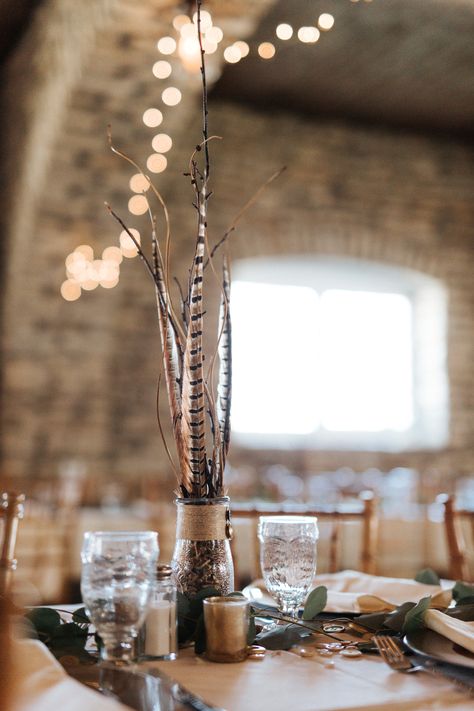 Pheasant feather wedding centerpieces in this Real Wedding featured on the Lake Bride Magazine blog. Find more here! #centerpiece #weddingcenterpieces #weddingdecor #weddingtables #minnesotawedding #hunting #huntingdecor #feathers #featherdecor Wedding Decor With Feathers, Boho Hunting Wedding, Turkey Feather Centerpiece Wedding, Pheasant Wedding Decor, Hunting Wedding Decor, Cat Tail Wedding Decor, Pheasant Feather Centerpieces Wedding, Feather Wedding Centerpieces, Pheasant Feather Centerpieces