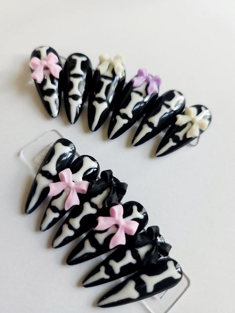 Bones and Bows A full Set of Halloween press ons that have a touch of cuteness. Short length stiletto with hand painted nail art. Set includes 20 nails, plus nail care kit as well.