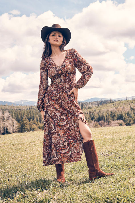 Effortlessly stylish, the Wrangler Paisley Maxi Dress sets the tone for a fall Western-inspired look. A paisley print, flattering v-neck, and peasant sleeve gives all the boho vibes you know and love. Complete the look with a tall cowgirl boot and a Western hat. Cowgirl Dresses With Boots, Wrangler Dresses, Mom Uniform, Cowgirl Dresses, Button Front Maxi Dress, Peasant Sleeve, Dress Sets, Western Hat, Paisley Maxi Dress