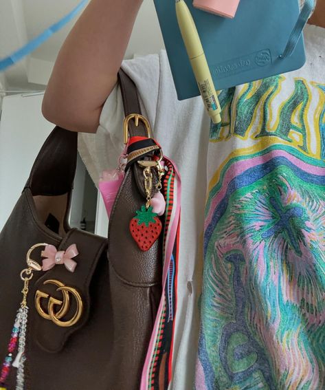 pov: you’re a maximalist who just rolled out of bed and ready to multitask without caffeine ☕️ 🖊️😵‍💫⭐️💳📱📧👛 🫨🔑📮💻 💄👩🏻‍💻📚 Miu Miu Brown Bag With Detachable Strap, Bag Charm Trend 2024, Maximalist Bracelet Stack, Miu Miu Bag Charm, Brown Miu Miu Bag With Gold-tone Hardware, Re A, Multi Tasking, Handbags, Bed