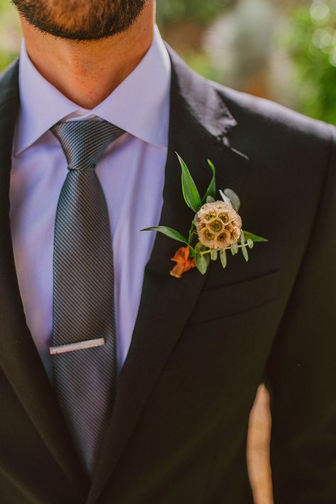 Paradise Valley Wedding - Unique greenery scabiosa pod boutonniere at this modern wedding and fall Arizona wedding. Greenery bouquets, greenery boutonnières, and floral arrangements. The fall wedding flower colors included a range of red, pink, orange, and peach, seen in the wedding flower arrangements, centerpieces, and arch flowers, perfect to match the desert wedding sunset. Photos by Olivia Markle. #fallwedding #weddingboutonniere #weddingflowers #weddings Sunset Colored Wedding, Colored Wedding Flowers, Blush Boutonniere, Wedding Flower Colors, Black Wedding Suit, Unique Boutonniere, Burgundy Boutonniere, Greenery Boutonniere, Fall Boutonniere