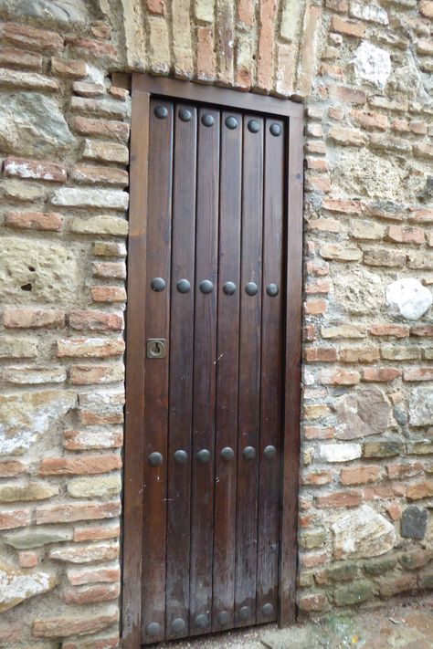 Brown wooden door at the Alcazaba a palatial fortification in Málaga, Spain. Entrance Ways, Wooden Doors, Malaga, Tall Cabinet Storage, Front Door, Entrance, Arch, Portugal, Spain