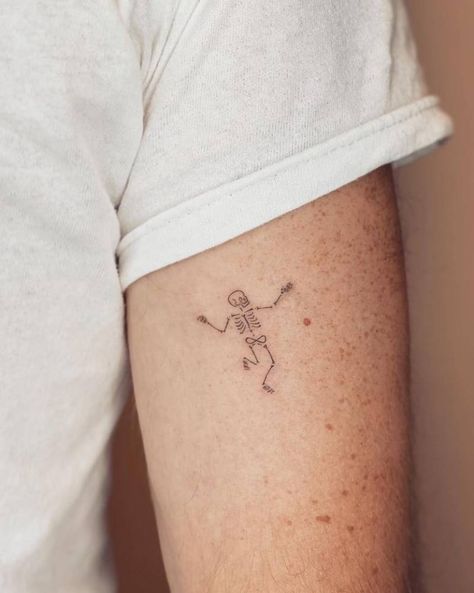 Fine line style dancing skeleton tattoo located on the Fall Related Tattoos, Dancing Skeleton Tattoo Simple, Halloween Fine Line Tattoo, Skeleton Flash Tattoo, Fine Line Skeleton Tattoo, Minimalist Halloween Tattoo, Fine Line Halloween Tattoo, Cute Halloween Tattoos Ideas, Tiny Skeleton Tattoo