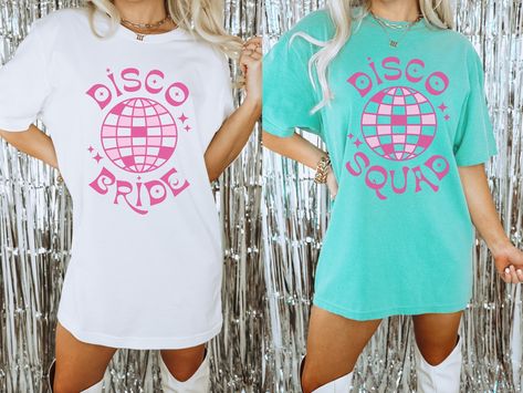 Disco Bride and or Disco Squad bachelorette t-shirt is a fun and stylish way to celebrate the bride-to-be's last fling before the ring. This t-shirt features retro lettering with a 70's style disco ball graphic, making it the perfect accessory for a night out on the town with the bride squad.  To order one of each, please add the size and color to your cart and then add the next one to your cart separate. The white will always say Disco Bride and the other shirt colors will always say Disco Squad. These tees are Comfort Colors and are made to last using premium ringspun cotton, this creates an vintage-soft shirt. The soft-washed, garment-dyed fabric brings extra coziness to your wardrobe while the relaxed fit makes it an excellent daily choice. ✦ 100% Ringspun Cotton ✦ Color: White, Chambr Disco Ball Graphic, Disco Bride, Last Fling Before The Ring, Bachelorette T Shirt, Retro Lettering, Disco Dancing, Last Disco, Bachelorette Tshirts, The Only Exception