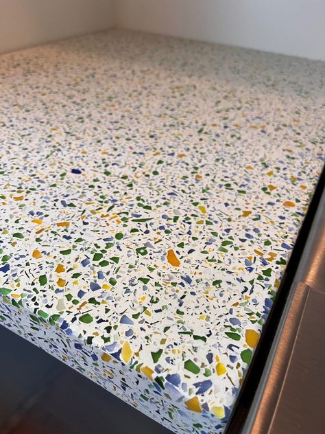 This client chose custom glass terrazzo with a white background for their concrete countertops. Concrete Terrazzo can be made in any color with any chips, either marble, granite or glass chips. Concrete chips can also be created for a very custom look! Concrete Terrazzo Countertops, Decorative Surface, Aggregates, Polished Finish, Custom Design, Versatile Material, Modern Aesthetics, Durable Countertops #TerrazzoCountertops #ConcreteTerrazzo #PolishedFinish Terrazo Countertop Bar, Terrazzo Countertop Kitchen, Terrazo Countertop, Terrazzo Countertops, Glass Terrazzo, Terrazzo Counter, Terrazzo Countertop, Countertop Bar, Modern Terrazzo